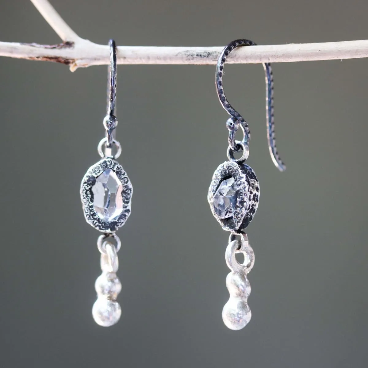 Earrings Clear quartz crystal in silver bezel setting with silver peanut on sterling silver hooks style