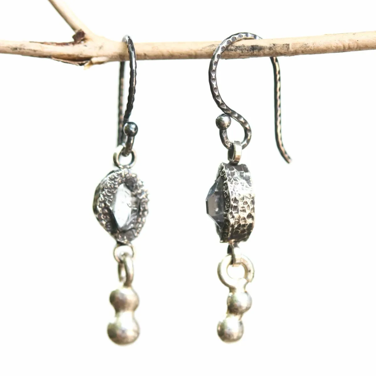 Earrings Clear quartz crystal in silver bezel setting with silver peanut on sterling silver hooks style