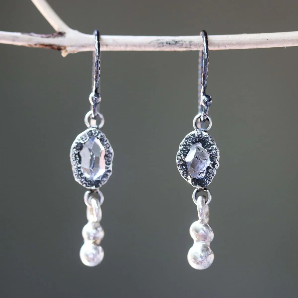 Earrings Clear quartz crystal in silver bezel setting with silver peanut on sterling silver hooks style