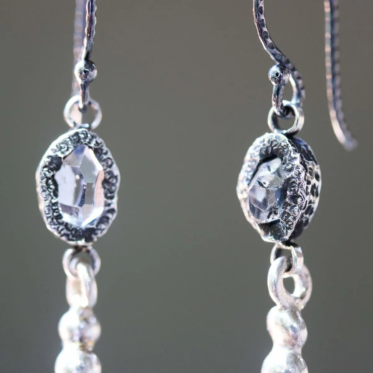 Earrings Clear quartz crystal in silver bezel setting with silver peanut on sterling silver hooks style